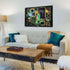 Stylish living room with framed Ravensburger Disney Villainous Maleficent puzzle on the wall, glowing green magical details and ornate golden frames displayed as decorative art.
