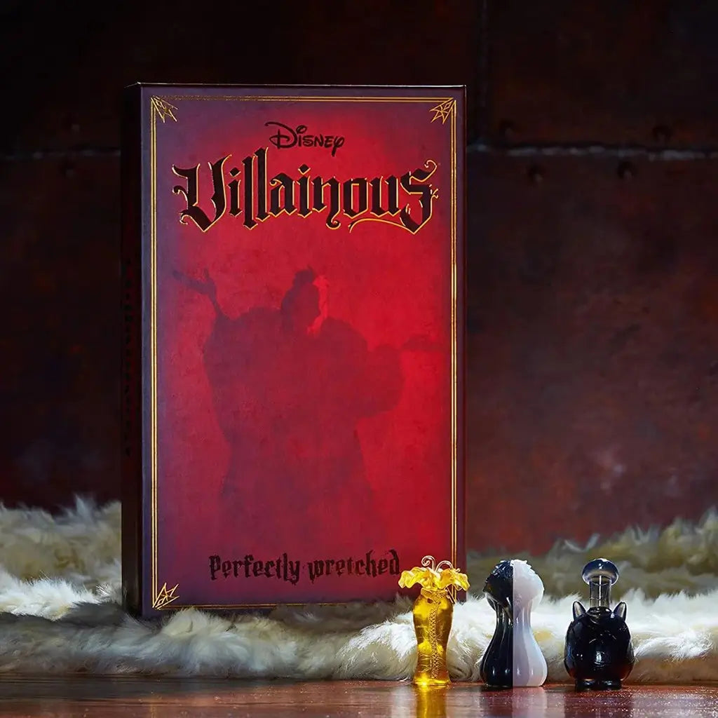 Disney Villainous: Perfectly Wretched game box posed with sculpted movers for Cruella de Vil, Pete, and Mother Gothel, set against a dramatic fur and wood background.