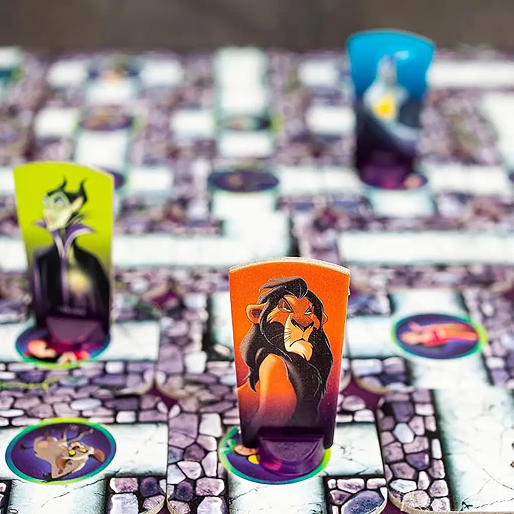 Close-up of Ravensburger Disney Villains Labyrinth board showing Scar and Maleficent character pieces on maze tiles, highlighting colorful artwork and interactive gameplay.