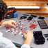 Box and completed Ravensburger Ferrari SF90 Stradale 3D Puzzle side by side, highlighting realistic model look.