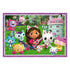 Cartoon Gabby from Gabby’s Dollhouse plays guitar on grass with cat companions of different colors near a teal dollhouse, surrounded by trees and flowers.