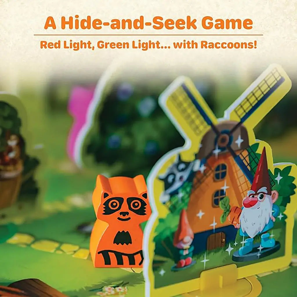 Ravensburger Garden Heist board game close-up shows an orange wooden raccoon figure next to a colorful cardboard windmill and gnome cutout, set on a green illustrated garden board.