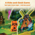 Ravensburger Garden Heist board game close-up shows an orange wooden raccoon figure next to a colorful cardboard windmill and gnome cutout, set on a green illustrated garden board.
