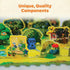 Close-up of Ravensburger Garden Heist board with a blue wooden raccoon piece placed among detailed cardboard trees, birdhouses, and flowers, highlighting the game’s unique illustrated components.