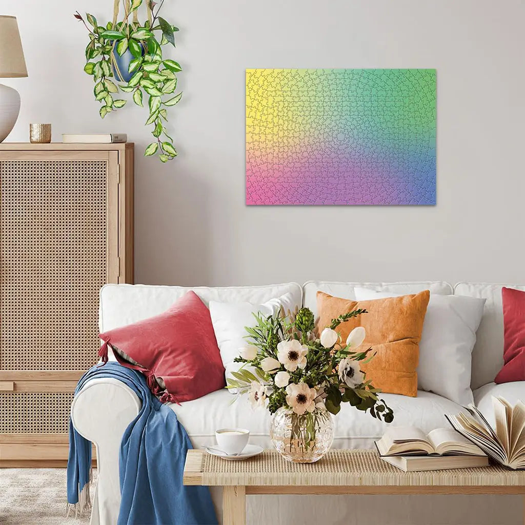 Modern living room with white sofa, colorful pillows, and plants displays the completed Ravensburger Krypt gradient puzzle framed on the wall as artwork.