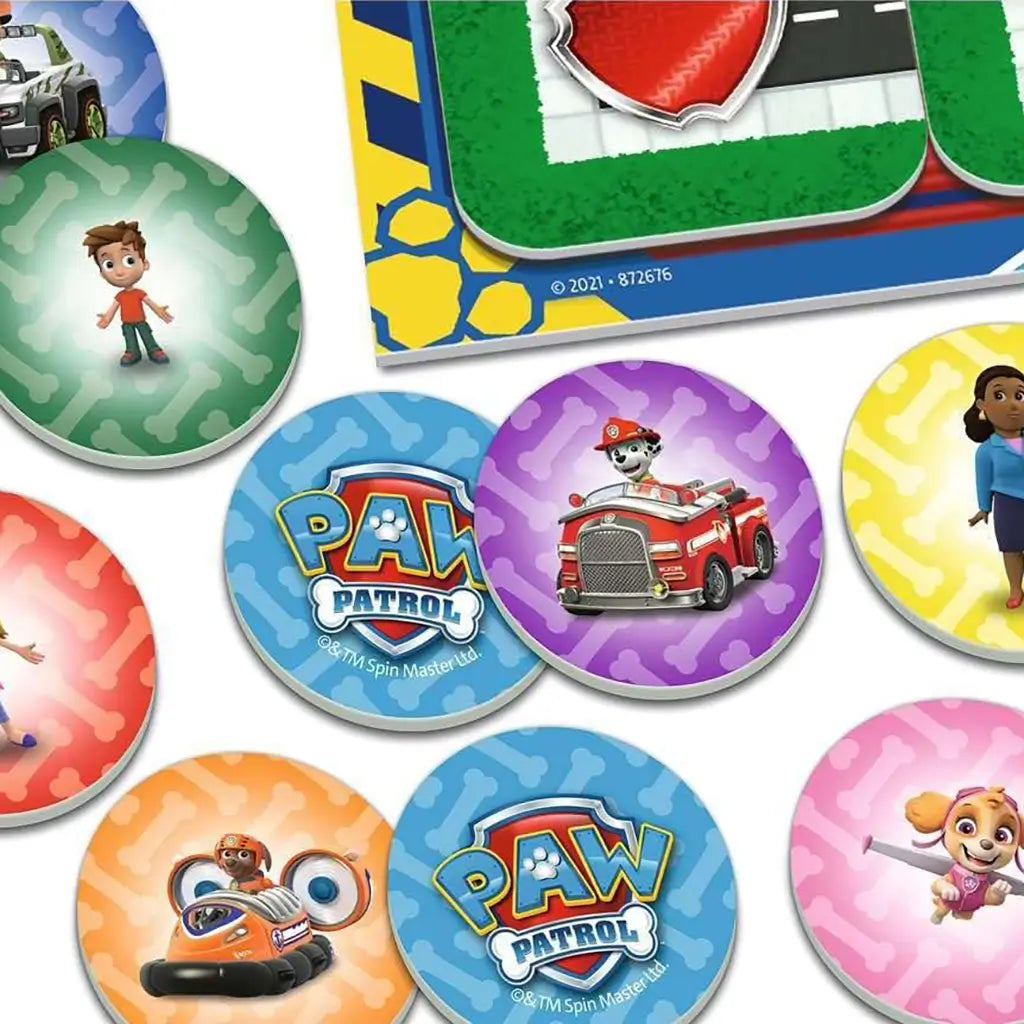 Colorful round cardboard tokens from Ravensburger’s Paw Patrol Junior Labyrinth game show characters like Ryder, Skye, and Marshall on textured backgrounds for matching play.