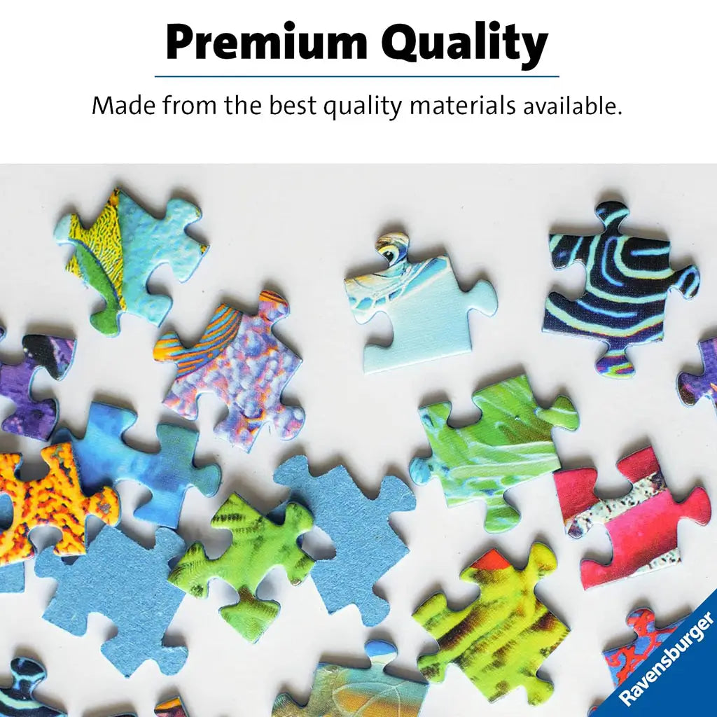 Bright Ravensburger puzzle pieces with glossy textures and vivid multicolor patterns lie scattered on a white background, highlighting the brand’s premium quality materials.