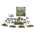 Complete Ravensburger Minecraft Heroes of the Village game set with box, cards, cubes, dice, character tokens, and cloth bag arranged neatly on a table.