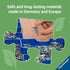 Hand holding puzzle piece over trays of parts, with green background and text noting Ravensburger puzzles use safe, durable materials made in Germany and Europe.