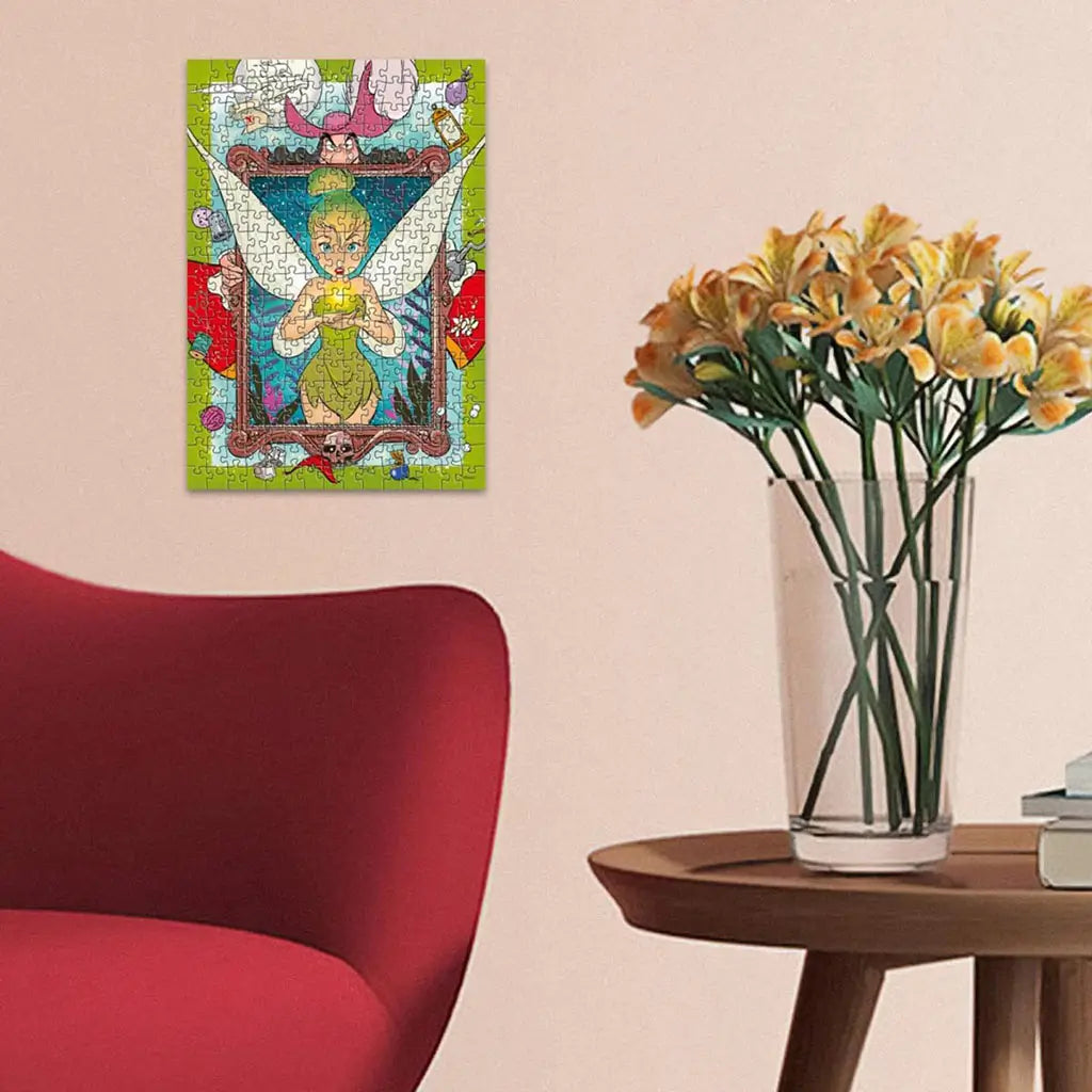 Completed Ravensburger Disney Tinker Bell 300 piece puzzle framed on wall above wooden side table with vase of yellow flowers, red chair in modern home setting.