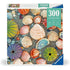 Ravensburger 300-piece Puzzle Moments box featuring colorful seashells and sea urchins on sandy beach pebbles, designed for a relaxing and mindful puzzling experience.