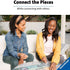 Two women smiling and assembling a Ravensburger puzzle outdoors on a white table, showing the social and relaxing experience of connecting puzzle pieces together in a casual setting.