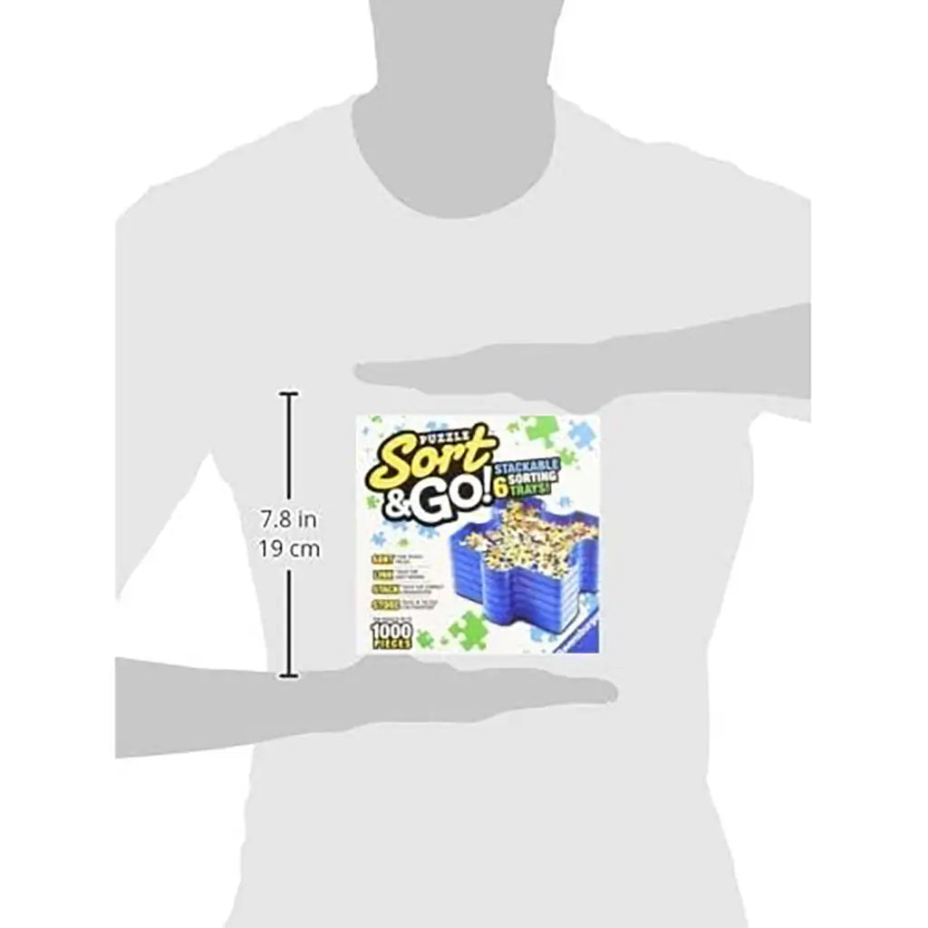Silhouette illustration showing person holding Ravensburger Puzzle Sort & Go box, measuring 7.8 inches tall, highlighting compact size of the storage system for organizing puzzles.
