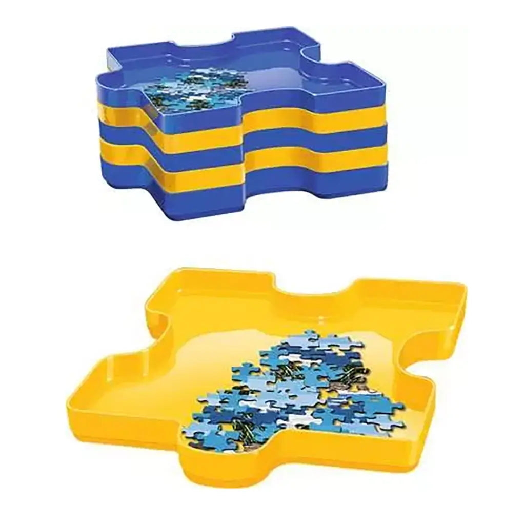 Stack of interlocking Ravensburger plastic trays in blue and yellow puzzle-piece shapes, each holding jigsaw pieces, designed for sorting and compact storage of puzzle sections.