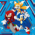 Puzzle image features Sonic, Tails, and Knuckles in energetic stances against a blue geometric background with red and white patterns, emphasizing teamwork and speed.
