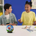 Two excited children sitting at a table with a completed Sonic the Hedgehog 3D puzzle ball between them, surrounded by pencils and school supplies.