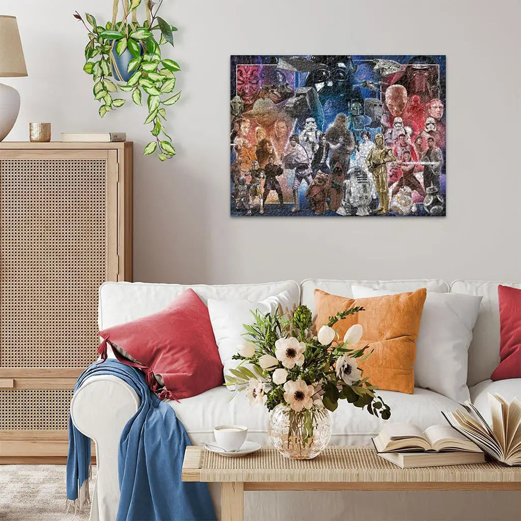 Completed Ravensburger Star Wars 1500 piece puzzle displayed on wall above white sofa with colorful pillows and flower vase in cozy modern living room setting.