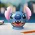 Completed Ravensburger Stitch 3D puzzle displayed on a desk next to a sharpened pencil, with blurred background suggesting a study or creative workspace.