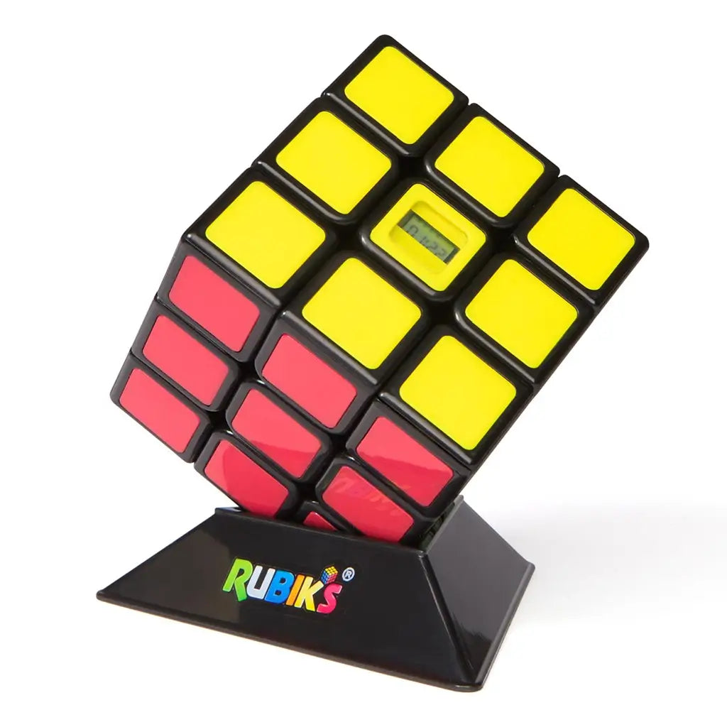 Rubik’s Timer Cube compact portable design shows a glossy black 3x3 cube with yellow and red tiles, angled on a branded stand, featuring an integrated LCD timer on one face.