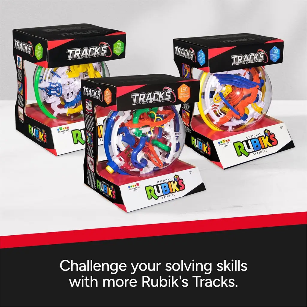 Rubik’s Tracks collectible set displays three clear plastic maze spheres in black and red packaging, each featuring colorful internal tracks and labeled with 70, 100, and 150 obstacles.