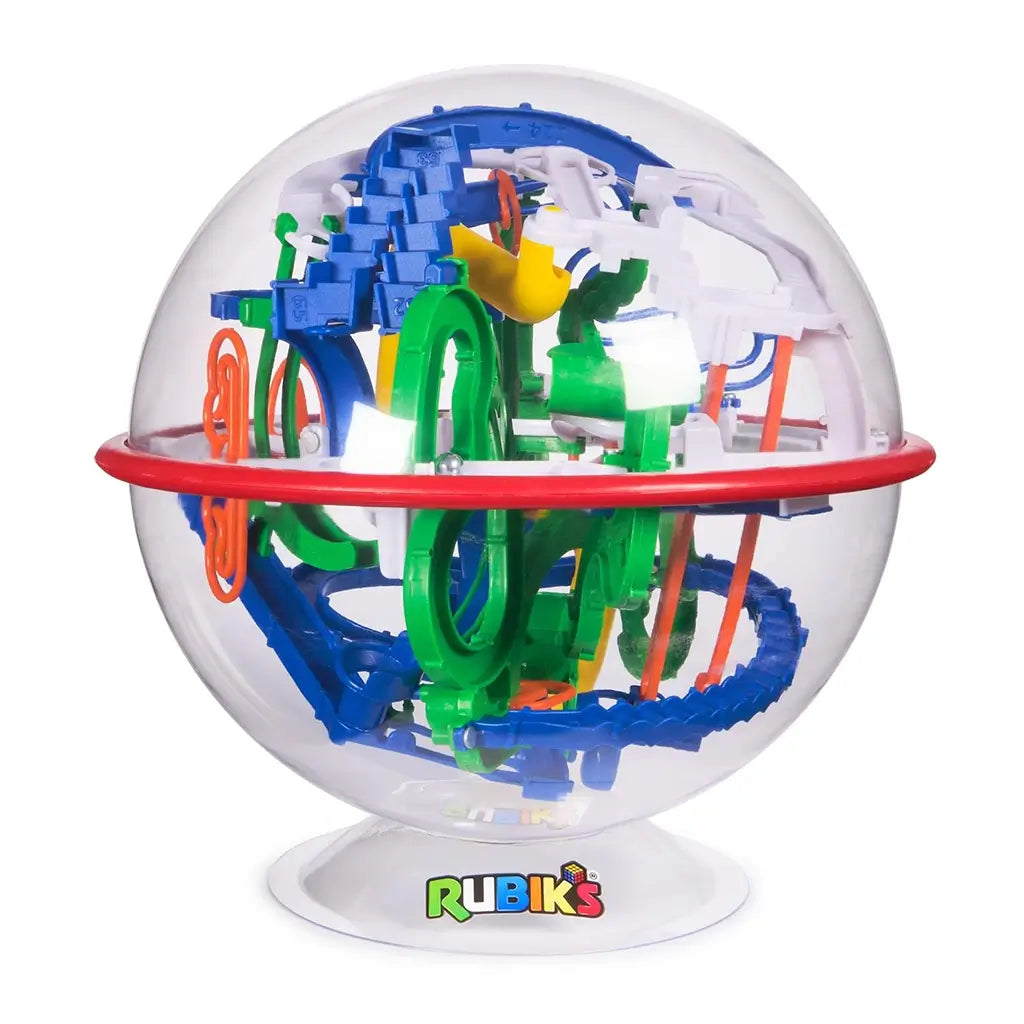 Rubik’s Tracks 3D gravity maze ball displays a clear spherical shell with red outer ring and interwoven blue, green, white, and yellow obstacle paths, mounted on a white base with Rubik’s logo.