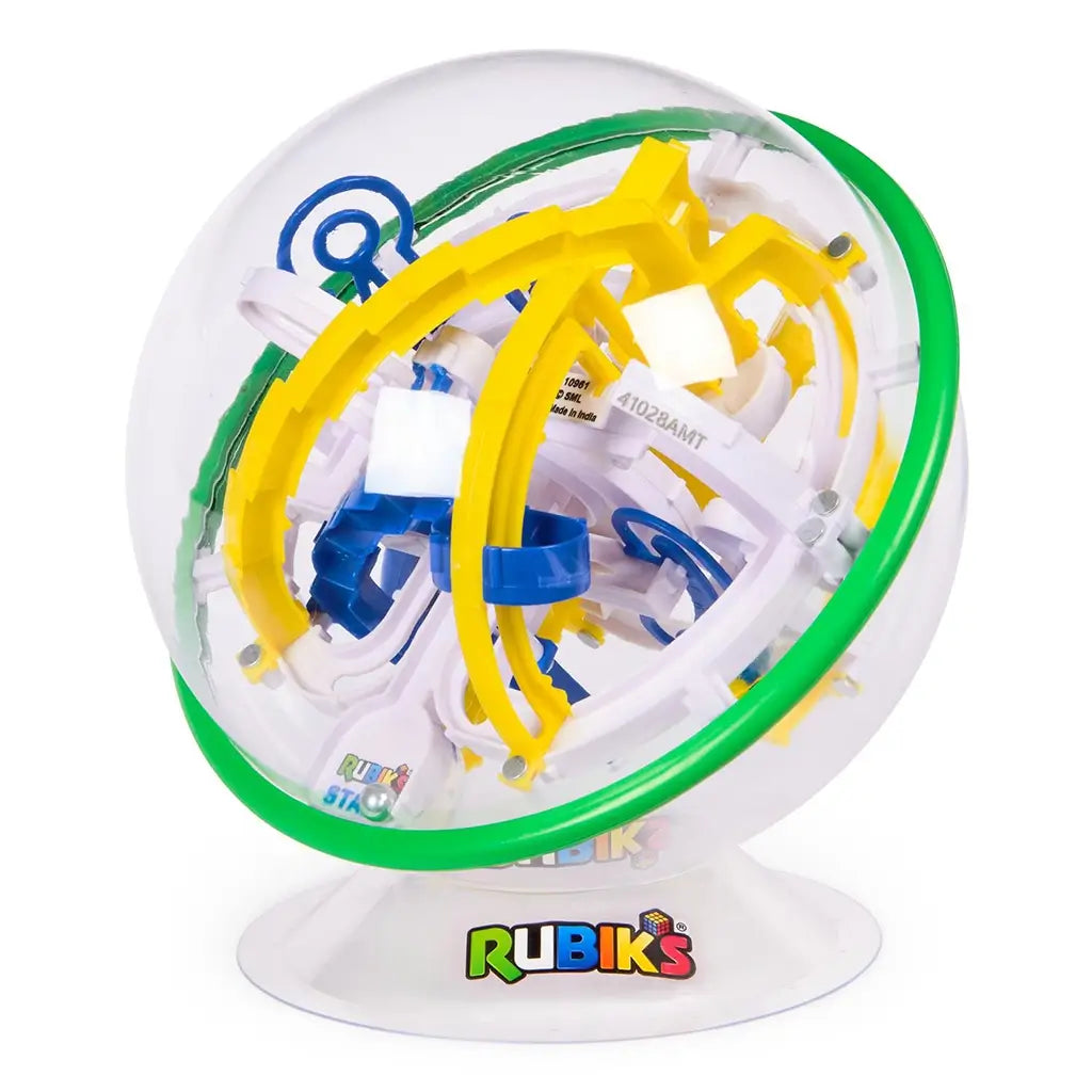 Rubik’s Tracks gravity maze front view presents a transparent spherical casing with green band and interlocking yellow ramps, blue loops, and white frames on a white display base.