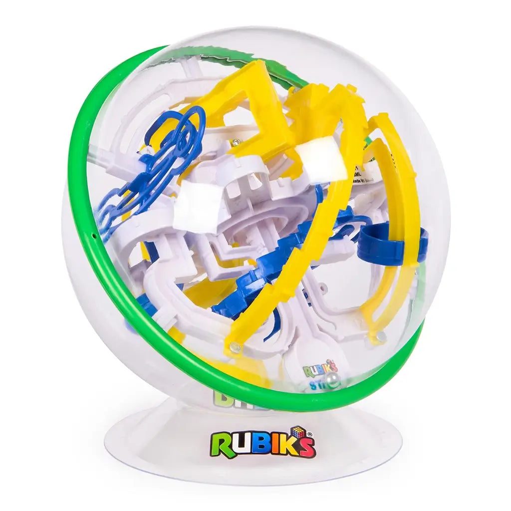 Rubik’s Tracks 70 obstacle maze ball shows a transparent plastic globe with green rim and layered yellow ramps, blue rails, and white pathways, mounted on a white base with Rubik’s logo.
