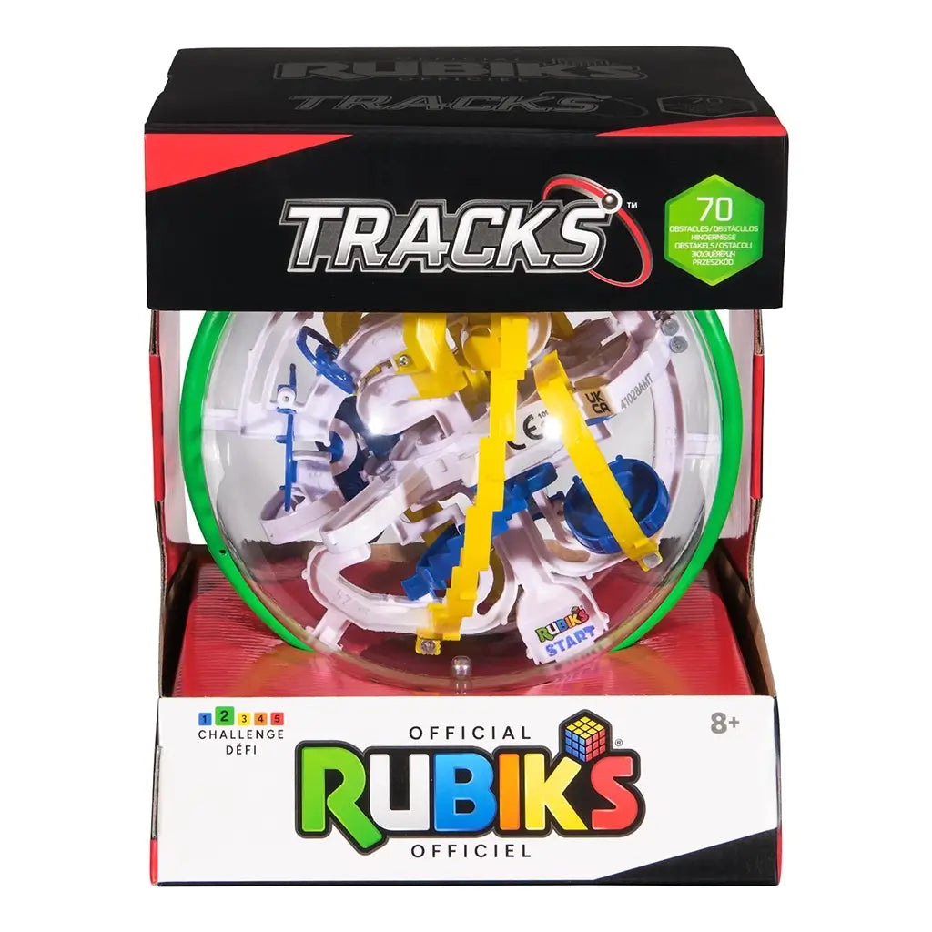Rubik’s Tracks 70 obstacles 3D gravity maze features a clear plastic spherical puzzle with green outer ring and yellow, blue, and white tracks, displayed in black and red retail packaging.