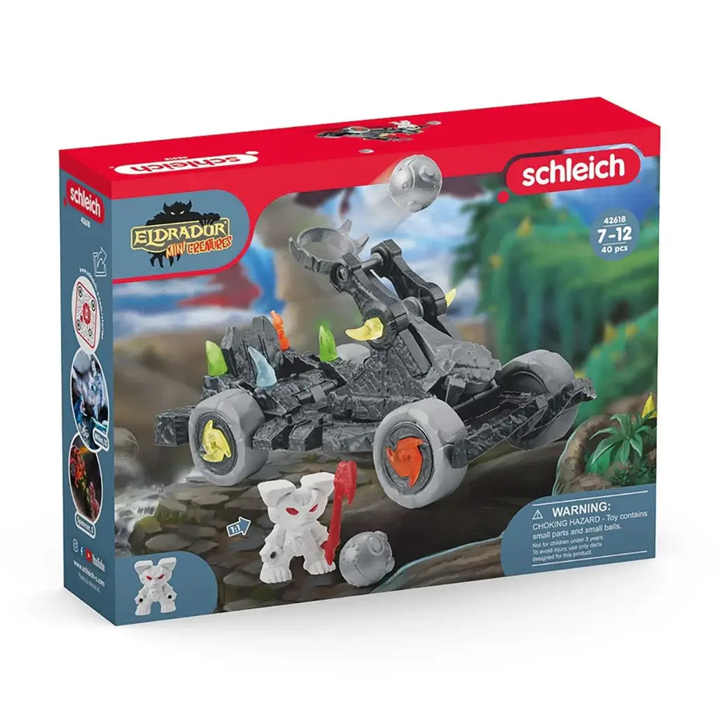 Schleich Eldrador catapult with mini creature retail box featuring red and blue cardboard packaging, fantasy artwork, age range labeling, and a clear illustration of the gray catapult vehicle and included accessories.
