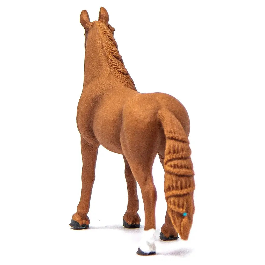 Schleich Horse Club German Riding Pony Mare figurine in chestnut brown molded plastic with textured coat and braided tail detail, shown from the rear to display muscular hindquarters and realistic stance on a white background.