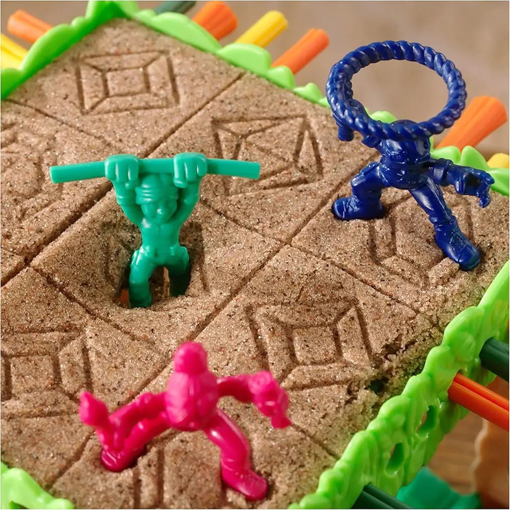Close-up of Sink N’ Sand characters in blue, green, pink, and orange standing on textured sand surface, each posed uniquely for jungle adventure gameplay.