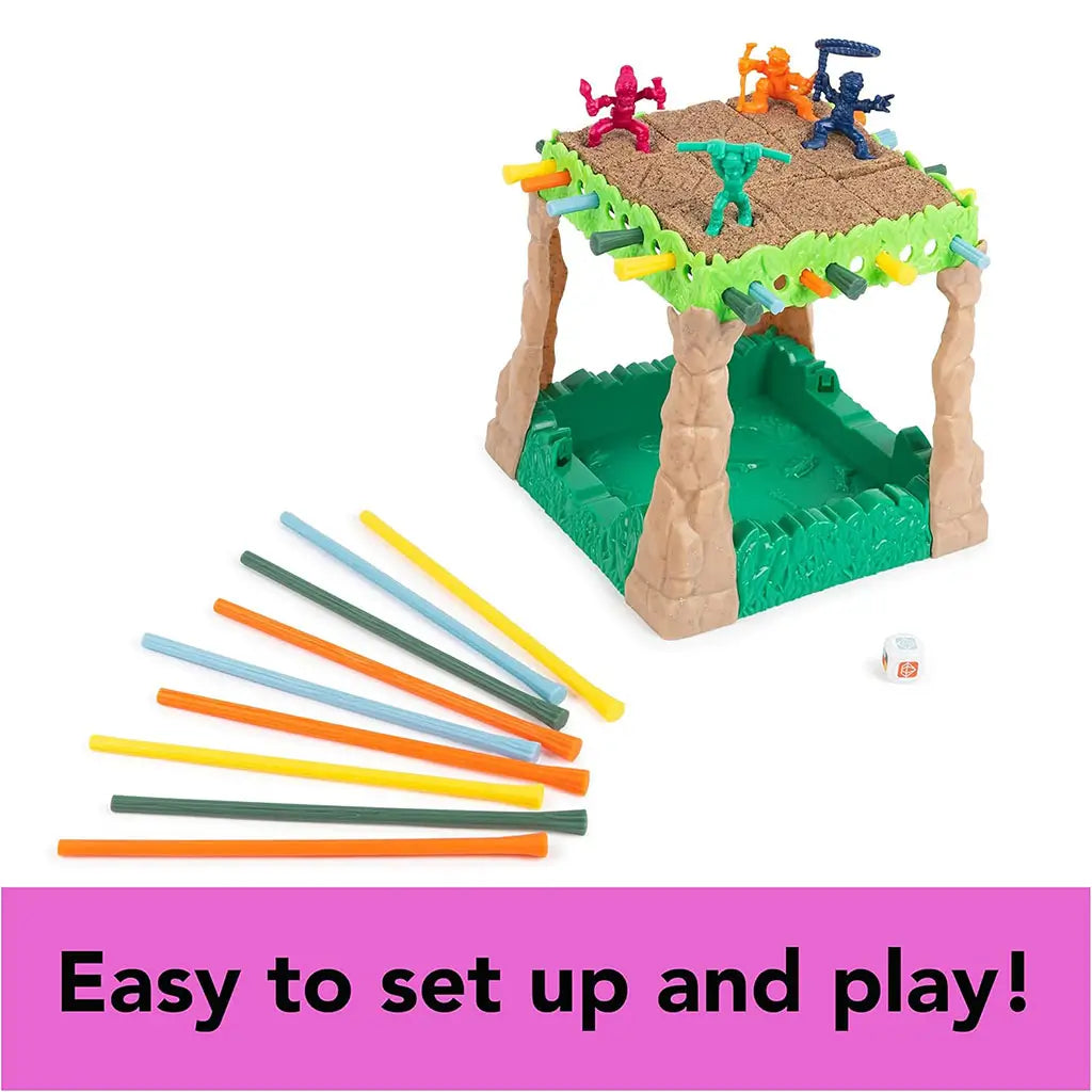 Sink N’ Sand board game partially assembled with explorer figures on sand platform, colorful sticks, and die laid out beside it, captioned “Easy to set up and play.”