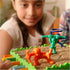 Smiling girl focuses on Sink N’ Sand board game, moving bright orange and green explorer figures across sand-filled platform supported by colorful sticks in play.