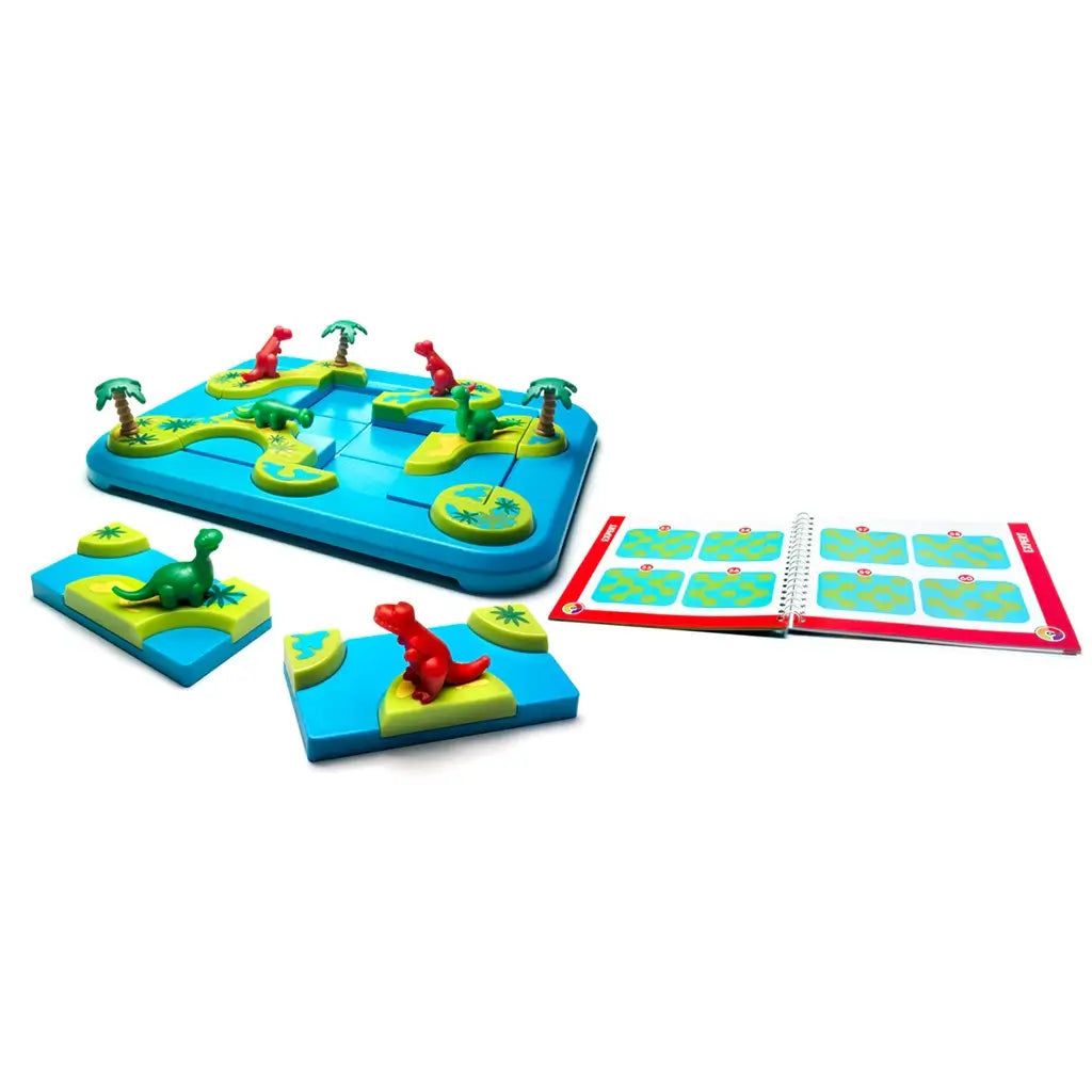 Smart Games Dinosaurs Mystic Islands puzzle set includes blue board with dinosaur island tiles, red and green dinosaur figures, palm tree pieces, and illustrated challenge booklet.