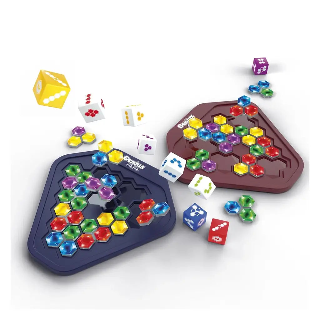 Genius Gems board game features red and blue hexagonal trays filled with multicolor jewel pieces, surrounded by white dice showing different colored symbols.