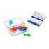Transparent plastic case filled with multicolored bubble puzzle pieces shown beside an open Smart Games IQ Bubbles challenge booklet with bright diagrams and numbered grids.