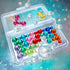Transparent travel-friendly Smart Games IQ Bubbles case shown open with shiny red, blue, green, and yellow puzzle pieces, displayed against a glowing teal and bubble-filled background.