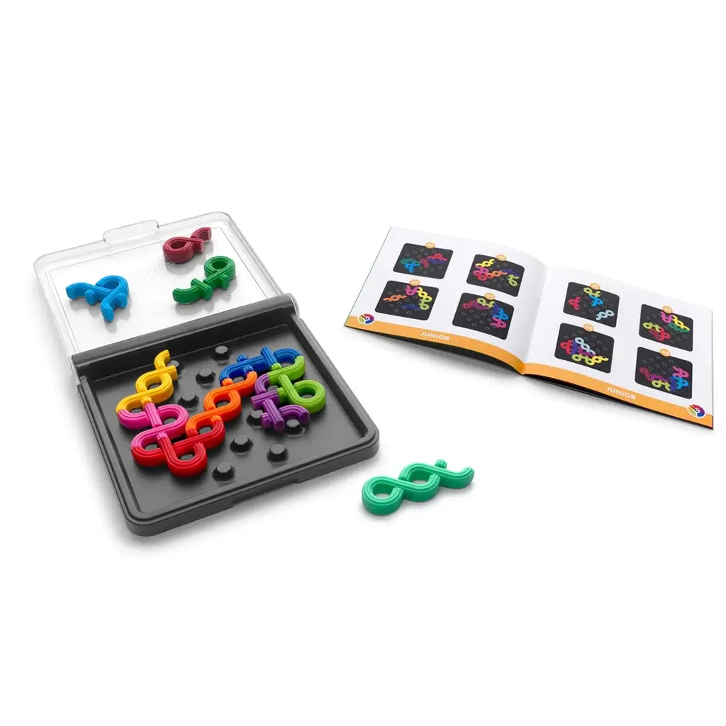 SmartGames IQ Noodles puzzle tray partially filled with flexible rainbow pieces, alongside an illustrated challenge booklet displaying various colorful grids.