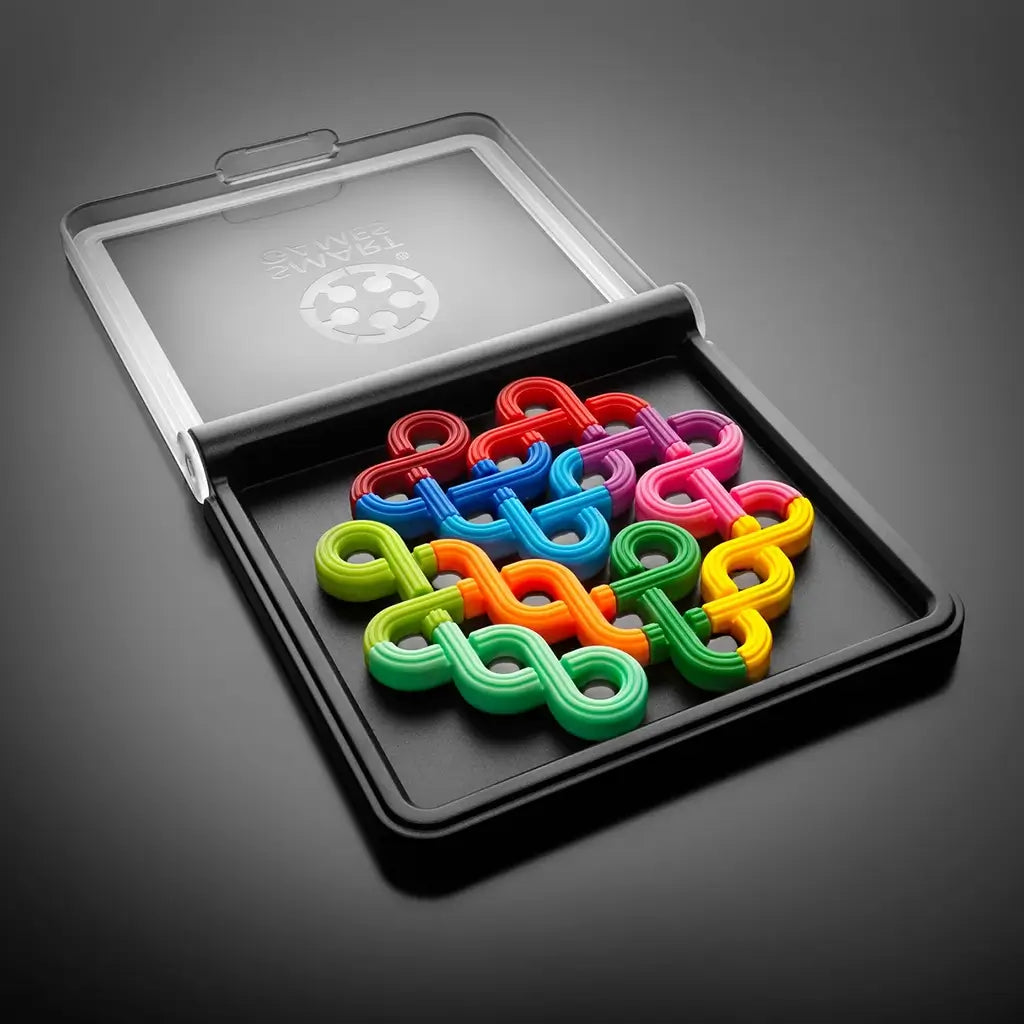 Open SmartGames IQ Noodles set with clear lid, black tray, and multiple curved noodle-shaped pieces in vivid red, green, yellow, purple, and blue.