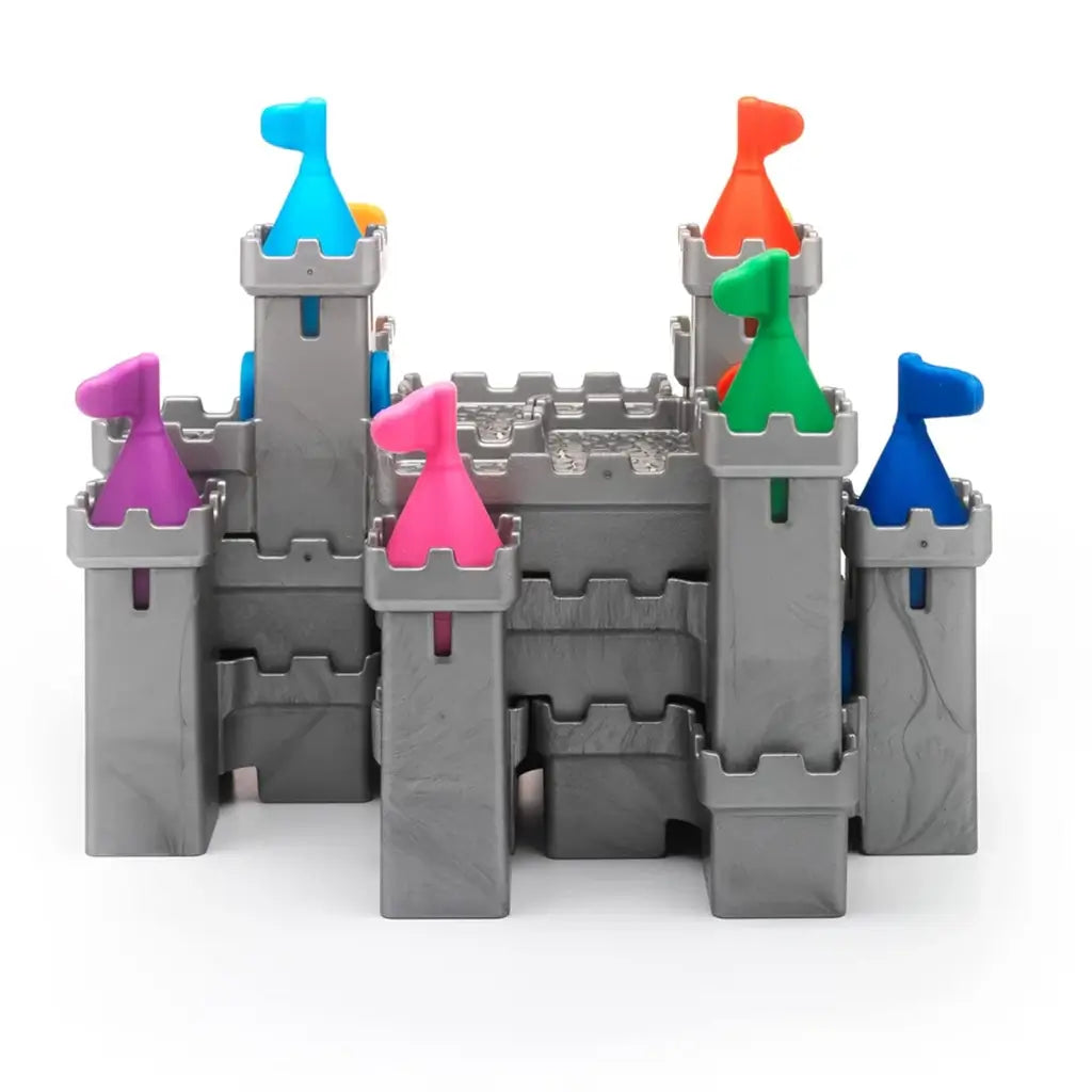 Completed Smart Games Tower Stacks castle puzzle built from gray interlocking towers, each topped with a brightly colored flag in pink, orange, blue, green, yellow, or purple.