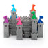 Completed Smart Games Tower Stacks castle puzzle built from gray interlocking towers, each topped with a brightly colored flag in pink, orange, blue, green, yellow, or purple.
