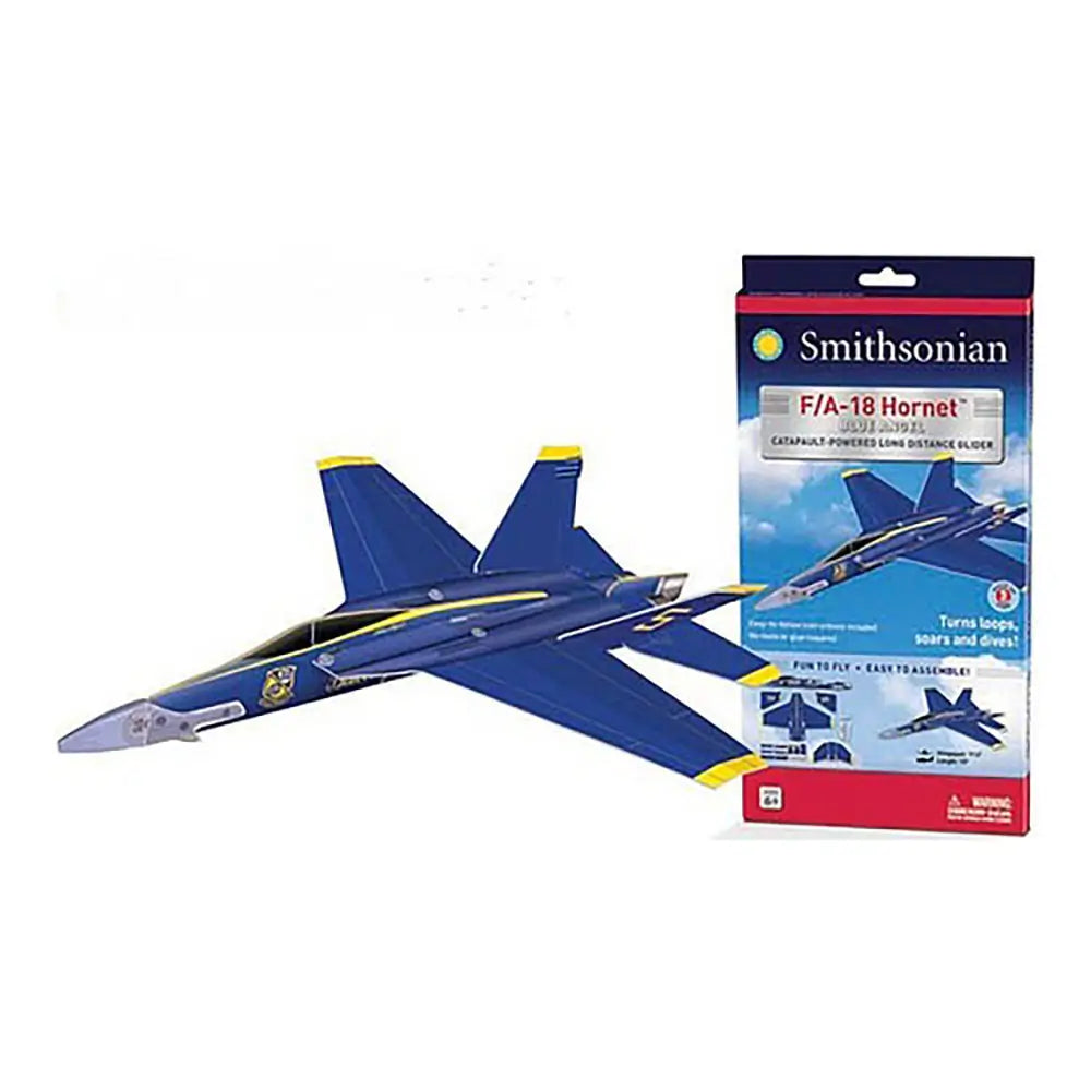 Smithsonian F/A-18 Hornet Blue Angels glider features bold blue and yellow foam wings with a sleek pointed nose and lightweight body shown beside the product box for long-distance catapult-powered flight demonstrations. 