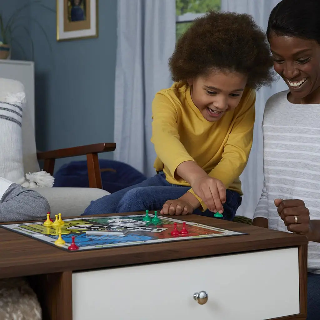 Sorry board game lifestyle image showing a child and adult playing together at a table, colorful pawns on the board, cards in hand, and a cozy living room setting emphasizing family-friendly tabletop entertainment.