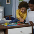 Sorry board game lifestyle image showing a child and adult playing together at a table, colorful pawns on the board, cards in hand, and a cozy living room setting emphasizing family-friendly tabletop entertainment.