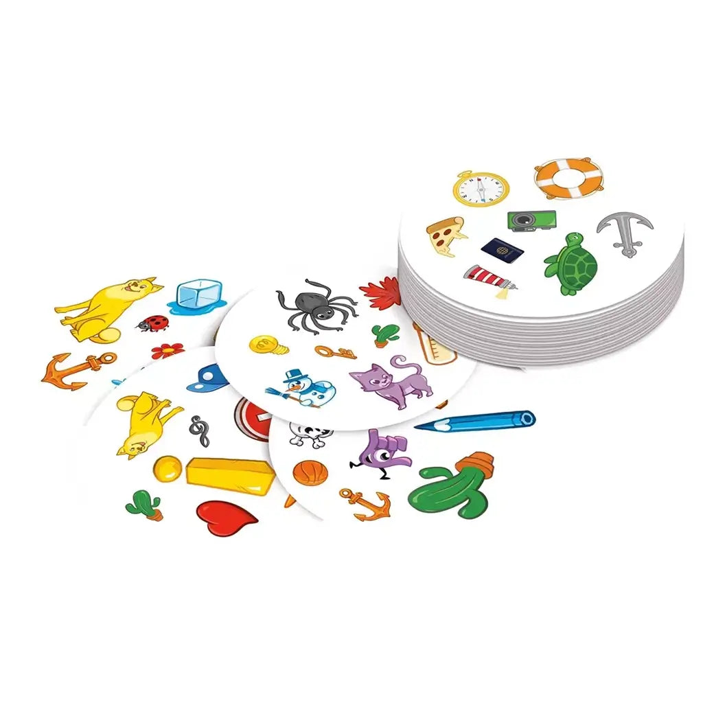 Spot It! Classic card game features white round cards with colorful symbols including animals, anchors, cactus, pencil, clock, turtle, and keys, spread in overlapping stacks.
