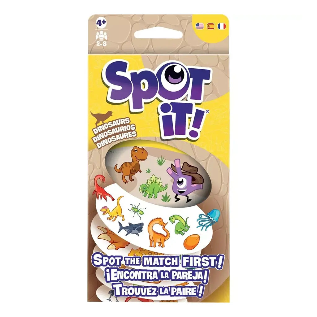 Spot It! Dinosaurs card game package features yellow and tan cardboard, a rectangular hanging box with cartoon dinosaurs, symbol cards, purple logo, and matching-game prompt.