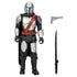 Mandalorian figure shown with included blaster and darksaber accessories against a white background, highlighting silver armor panels, brown strap and black cape for clear product visibility.