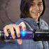 Child activating Star Wars Lightsaber Forge toy by pressing illuminated blue button on the translucent purple hilt, demonstrating lights and sounds during energetic imaginative Star Wars play.