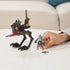 Poseable Star Wars Mission Fleet Tech Bad Batch AT-RT Ambush toy featuring black and red walker with articulated legs and red projectile, displayed with Tech figure and accessories on a white table.