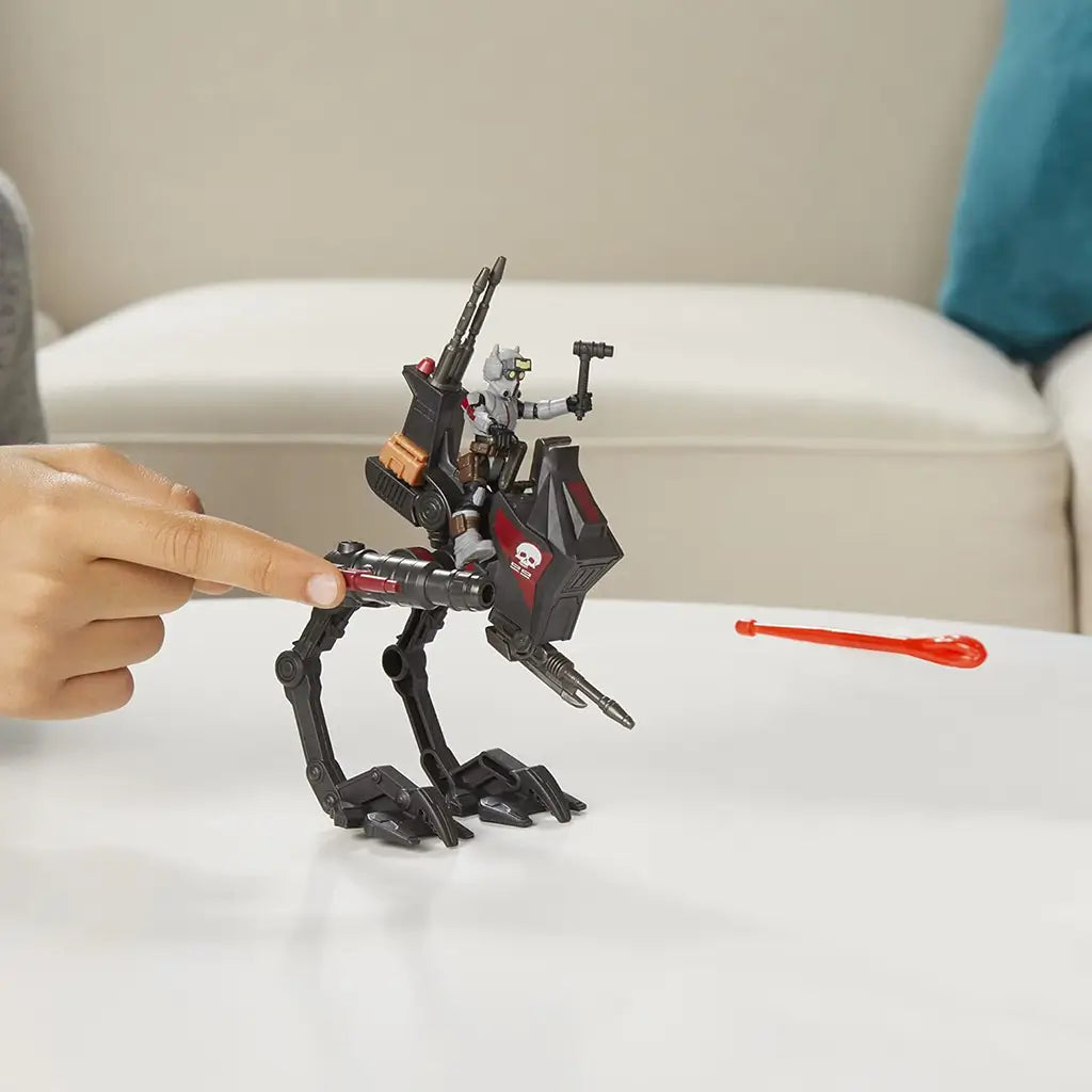 Star Wars Mission Fleet Tech Bad Batch AT-RT Ambush toy showing projectile launcher firing red bolt, with Tech figure riding the walker and hand pressing launcher button for play feature demonstration.